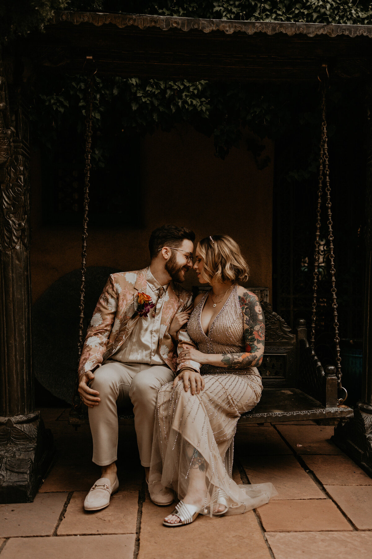 eloping couple sitting on a bench together in Santa Fe