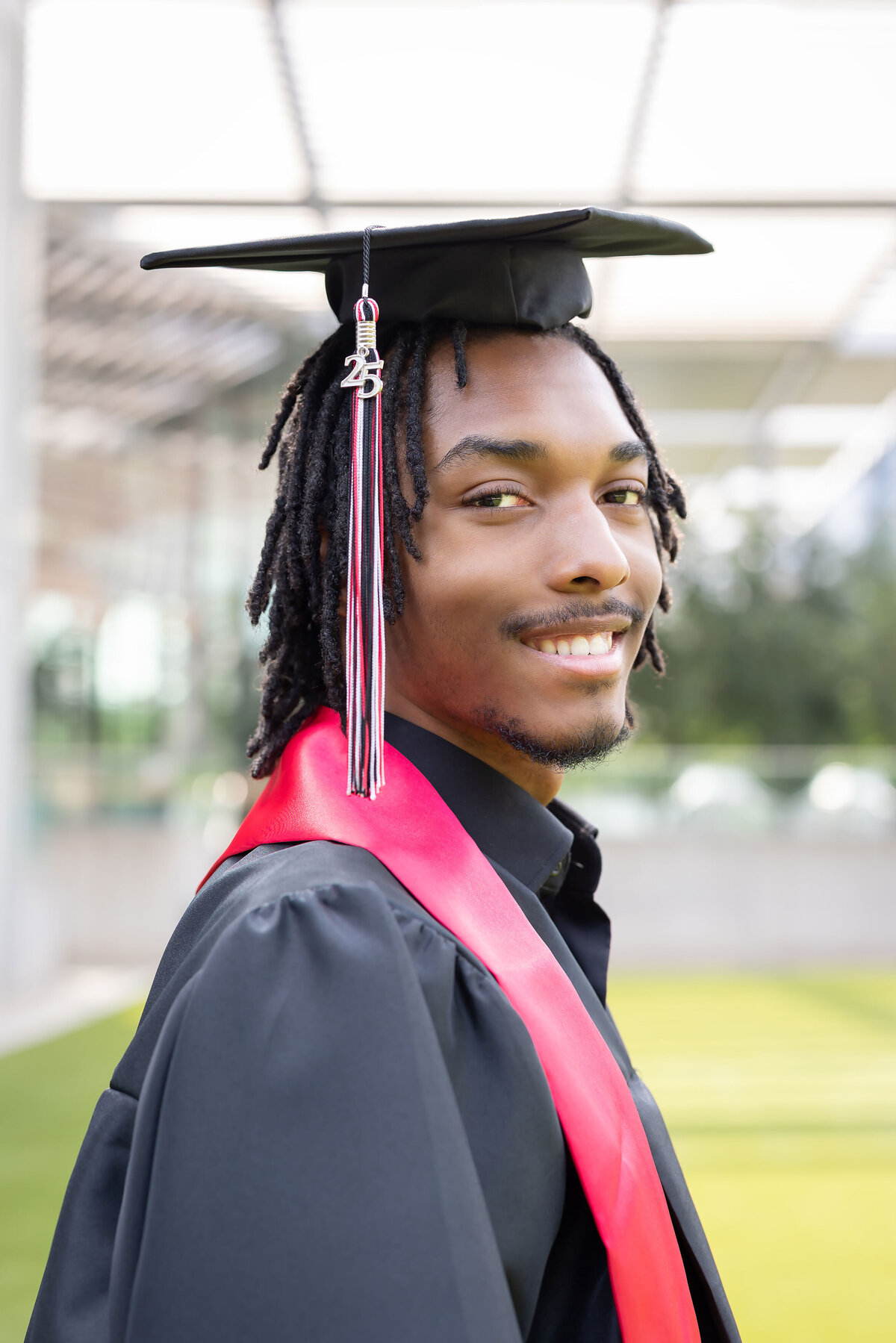 High school senior portrait of a young man in cap and gown, celebrating graduation for a professional Senior Photography Portfolio.