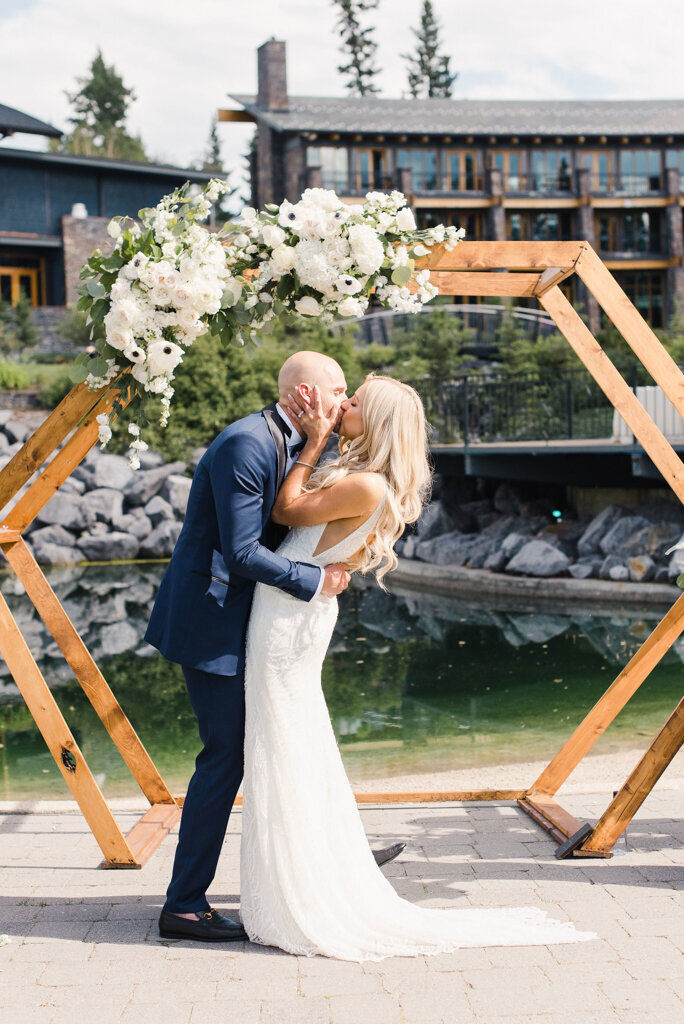 Bride and groom kiss during ceremony designed by More Events Co, featured on the Brontë Bride Vendor Guide.