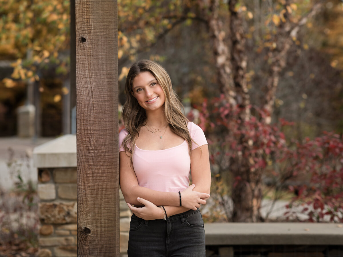 senior girl in pink shirt posing for senior portraits at Westcreek Reservation in Parma, Ohio
