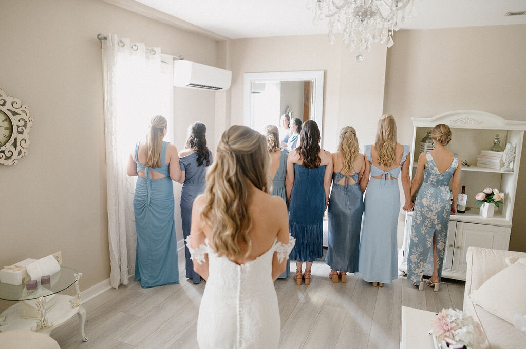 Bridesmaids about to see the first look on the bride