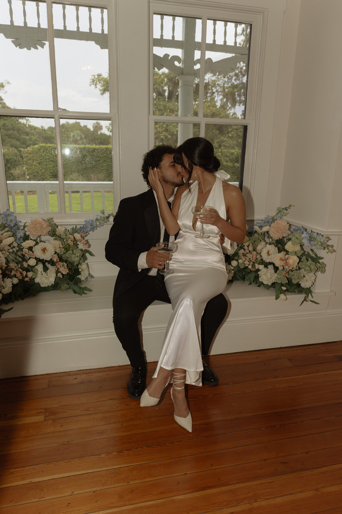 Luxury Florida wedding surrounded by tall palm trees and tropical details at The Palm Mansion in Umatilla