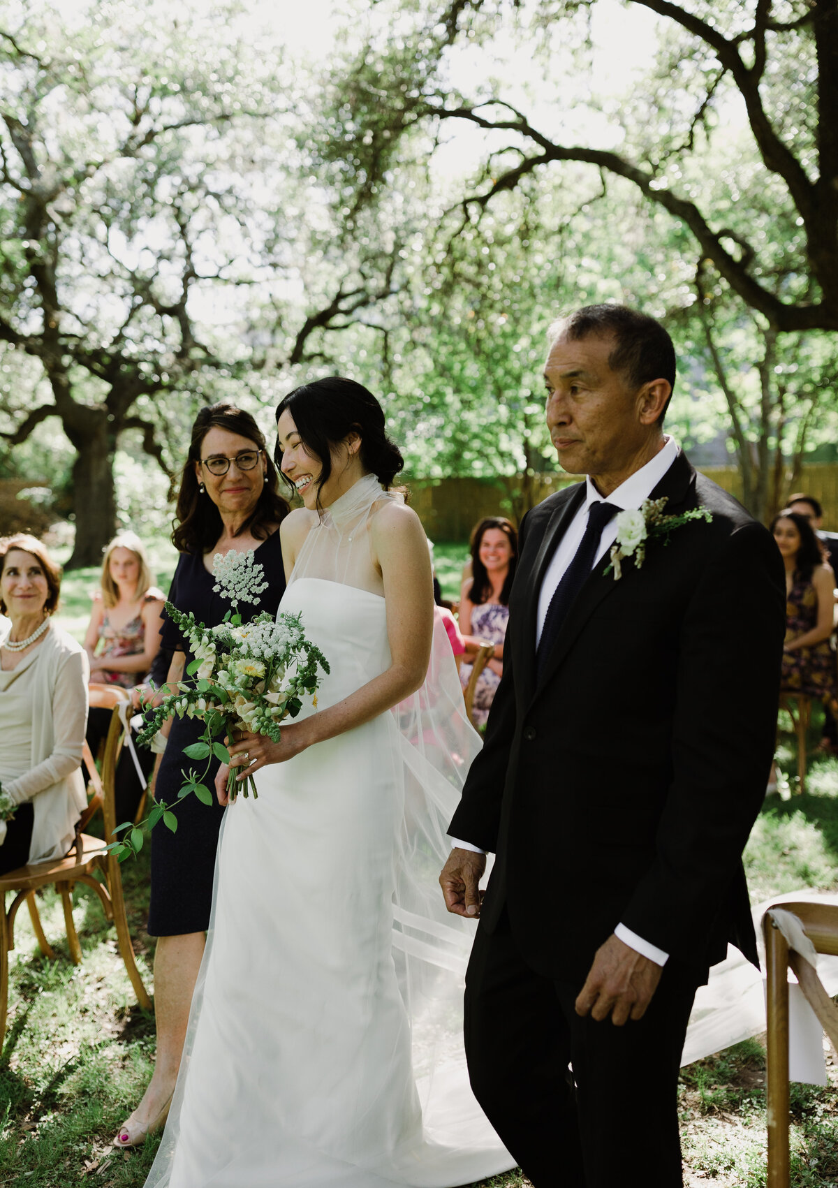 Bride walking down the aisle at outdoor wedding ceremony at  Mattie's Austin