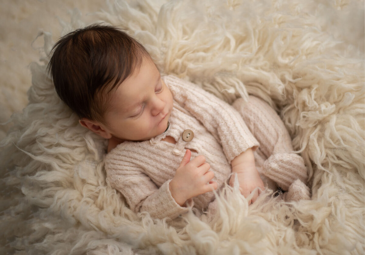 baby on cream wool layer sleeping