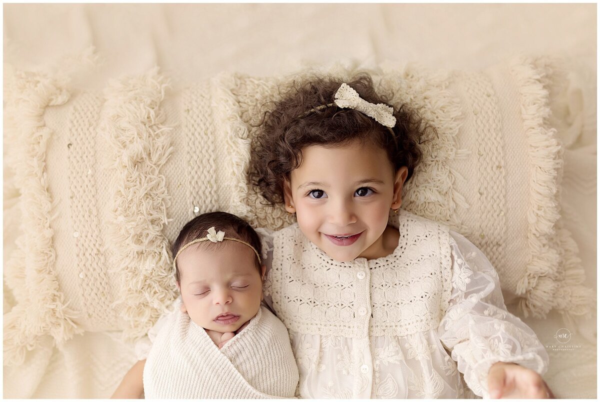 A sister sibling hug in a Medina portrait studio