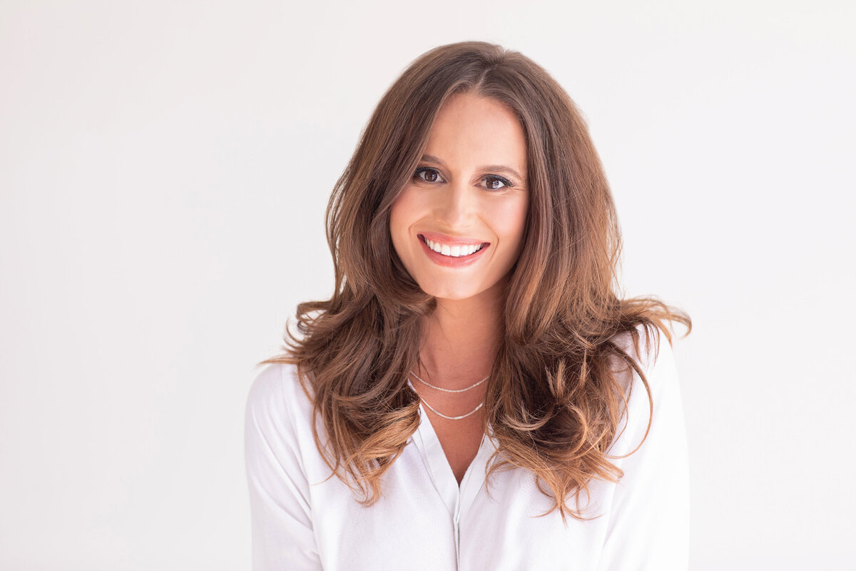 Professional woman with shoulder-length brown hair smiling warmly