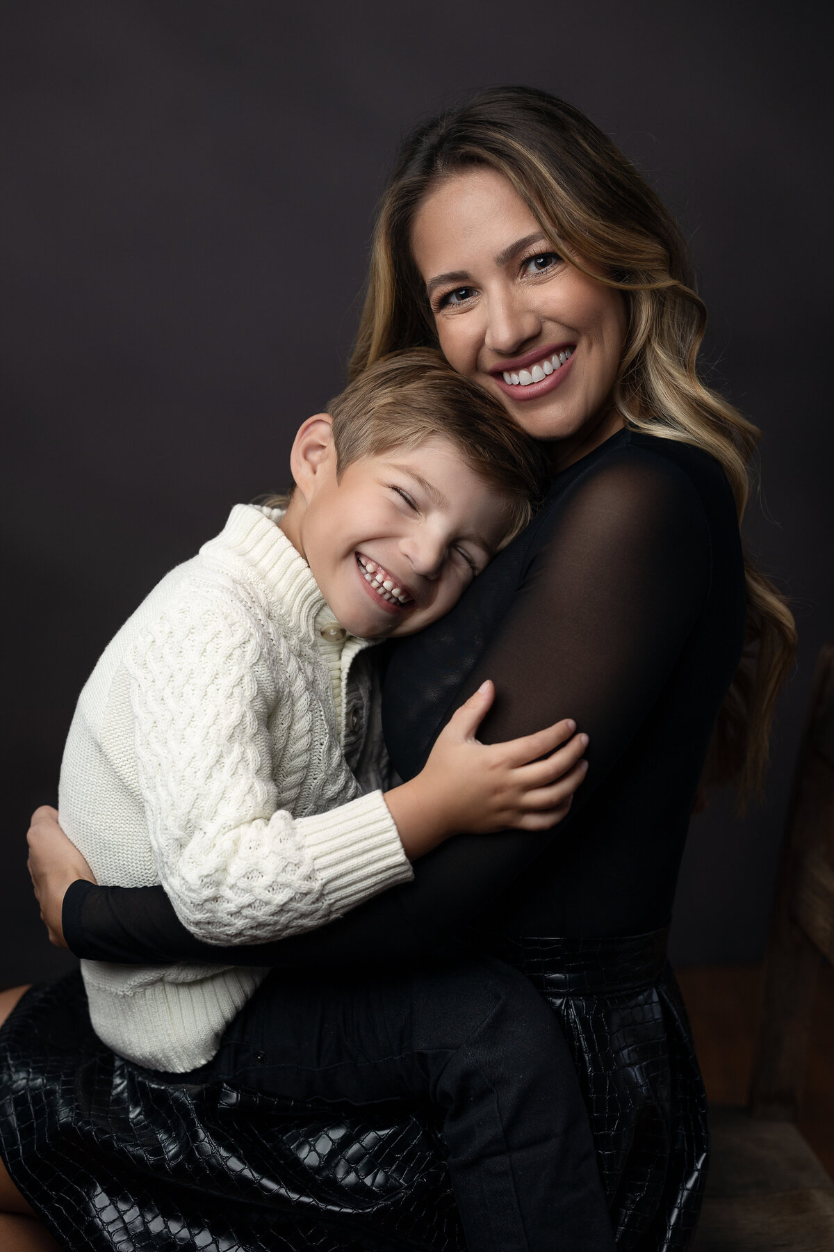 mom and little boy smiling in portrait session