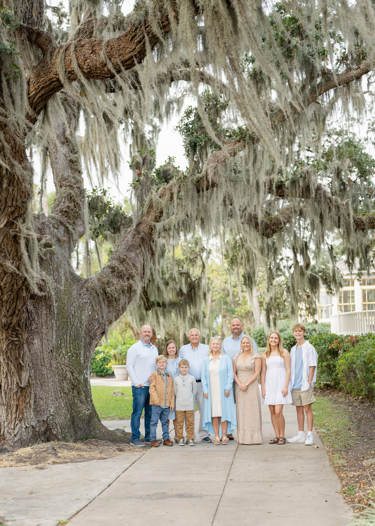 extended family photographed at jekyll island club under a beautiful live oak tree draped in spanish moss