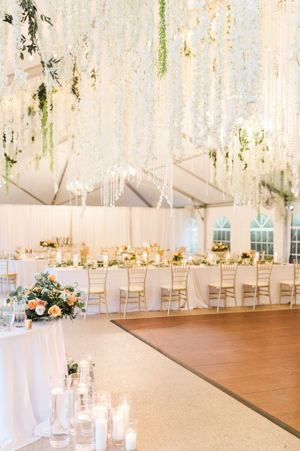 Indoor wedding reception designed with greenery and pink flowers