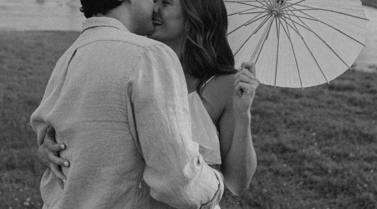 couple pose with parasol for engagement photos