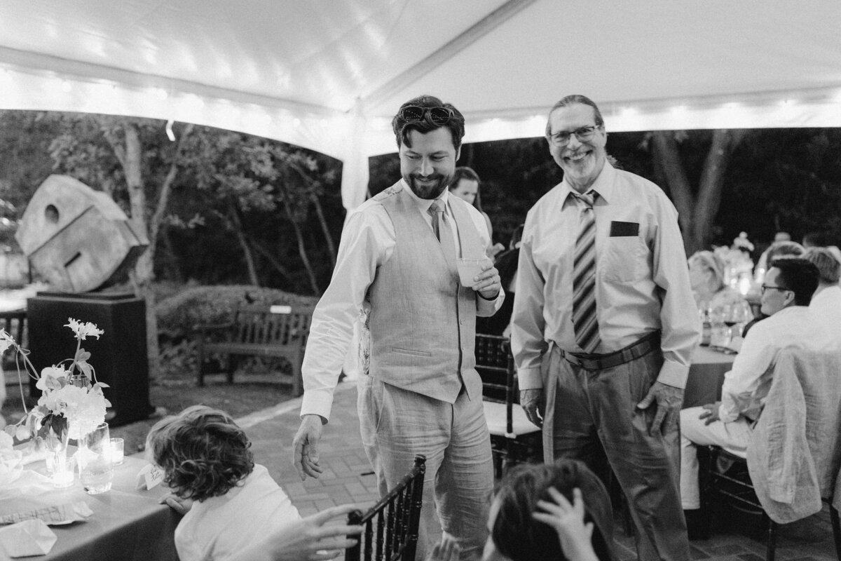 Two men at wedding reception at Umlauf Sculpture Garden, Austin