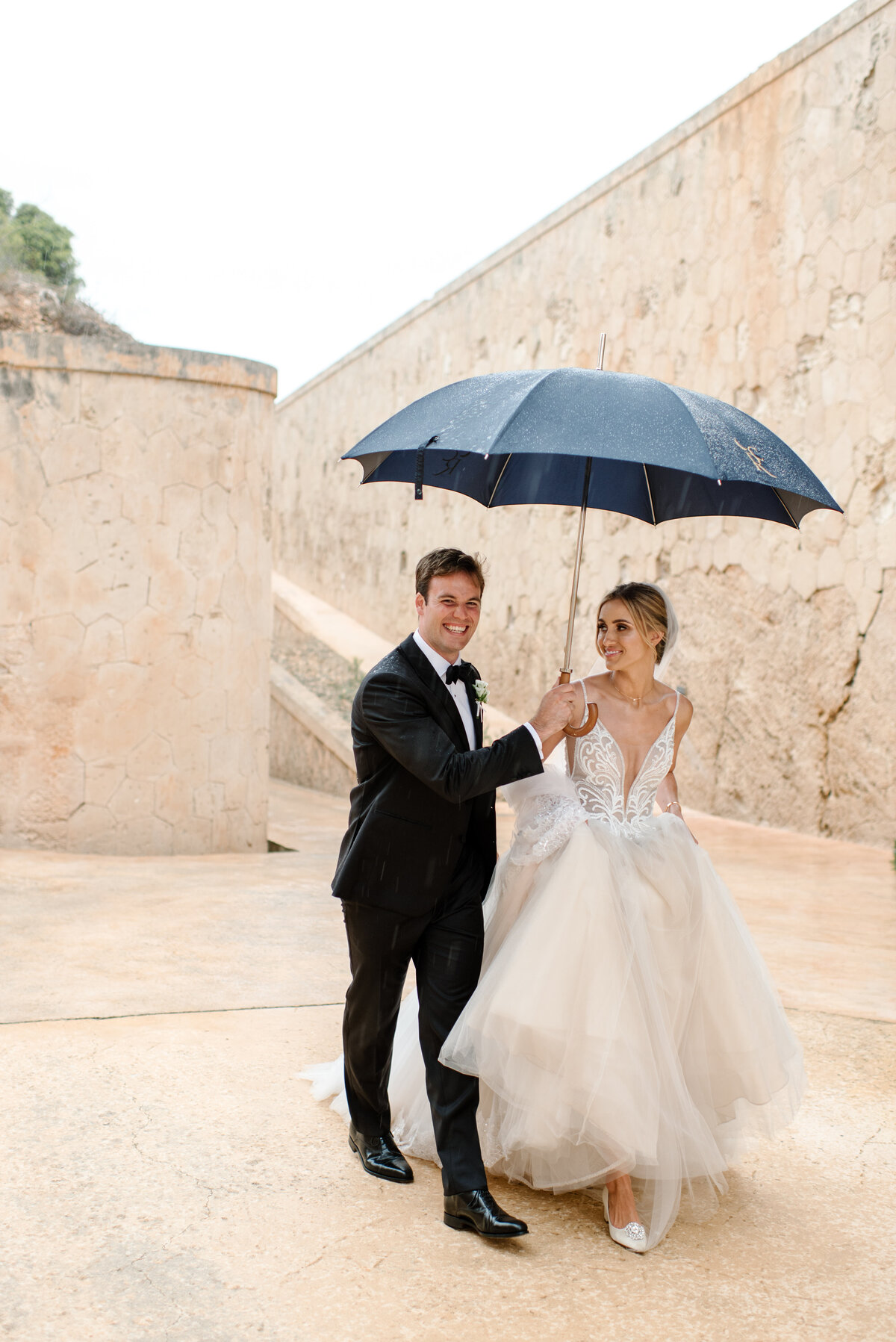wedding photo in the rain at cap rocat mallorca