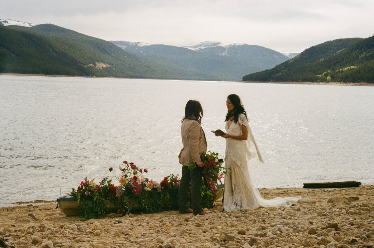 A bride reads her vows to her partner during her LGBTQIA+ elopement in Colorado.