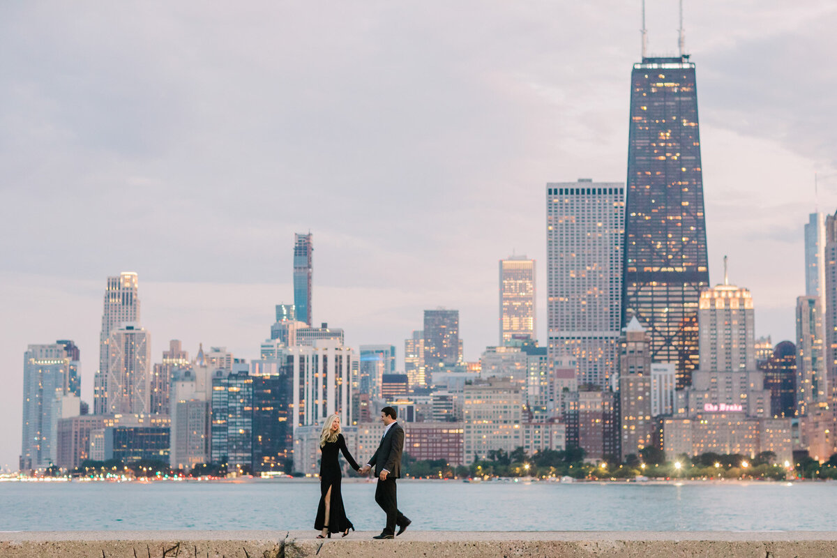 Chicago city lights glimmer in the background of this engagement photo