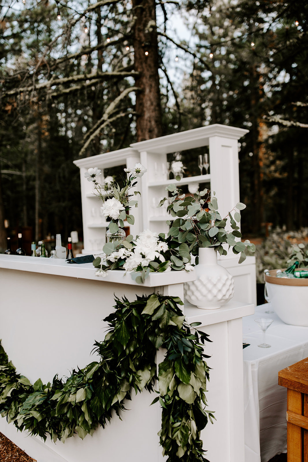 Lake Tahoe Wedding Planners white bar and bar shelves with eucalyptus runner at venue Mitchell's Mountain Meadows Sierraville near Truckee, Joy of Life Events image by The Shepards Photography