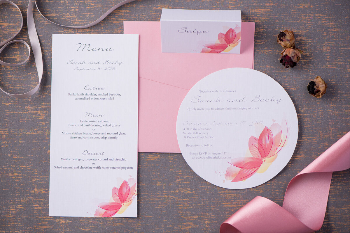 Pink floral wedding invitation in a round circle design with matching menu and tent place card