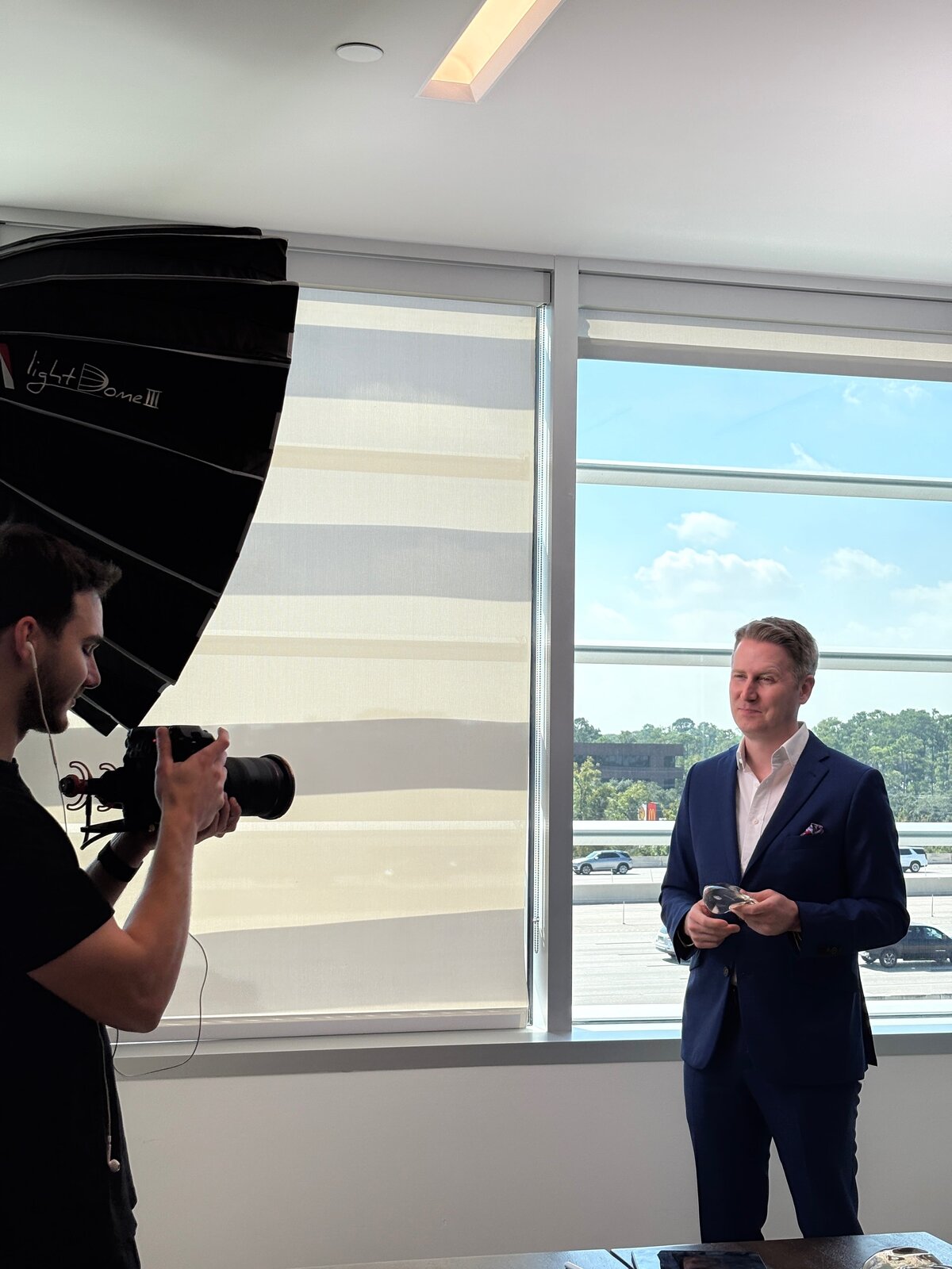 Luma Media photographer shooting a surgeon portrait by an office window