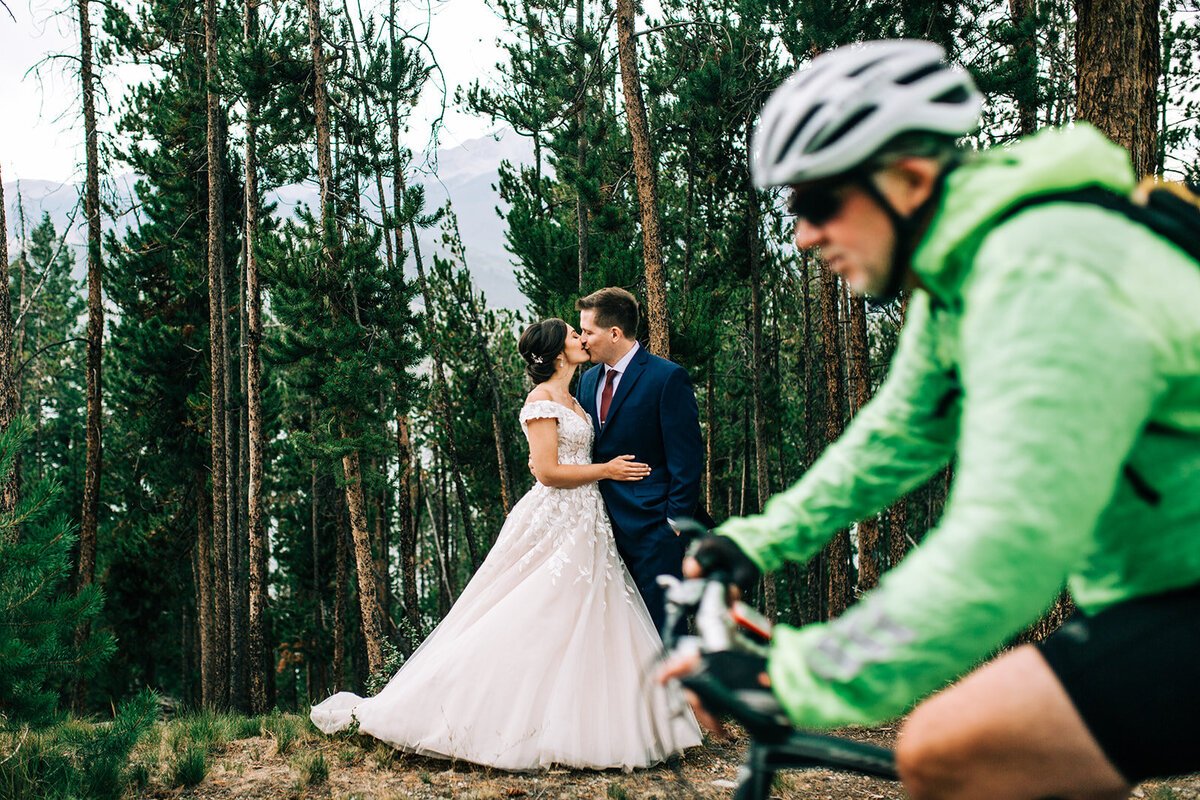 biker riding by bride and groom