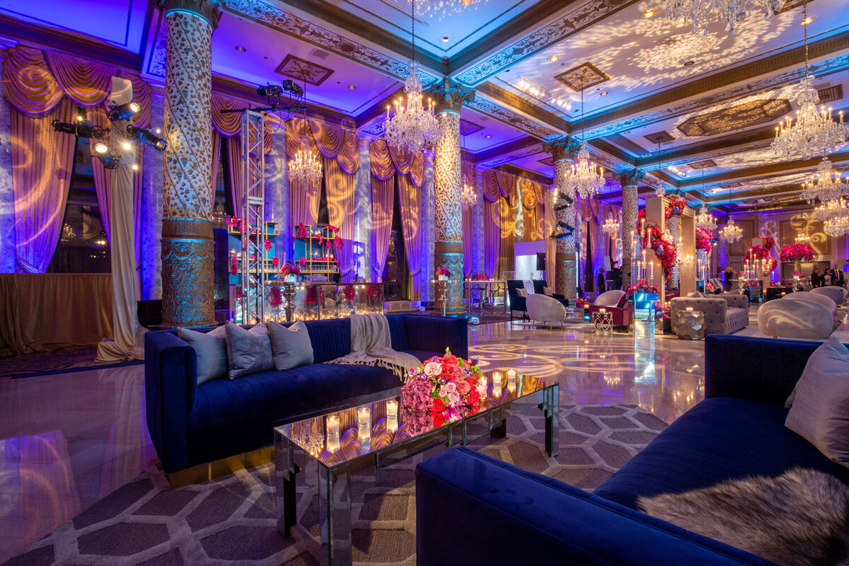 Elegant lounge with blue sofas and chandeliers