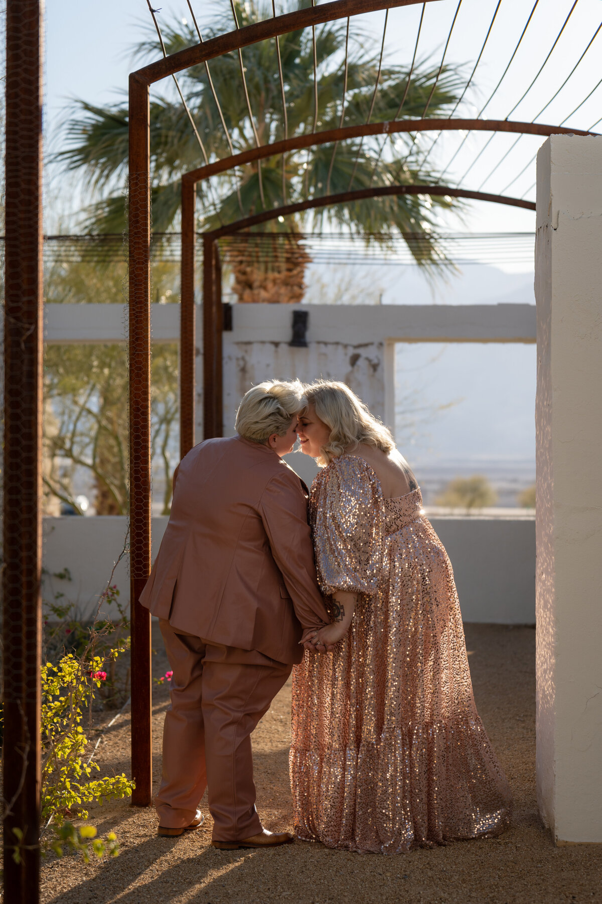 A couple standing forehead to forehead about to kiss