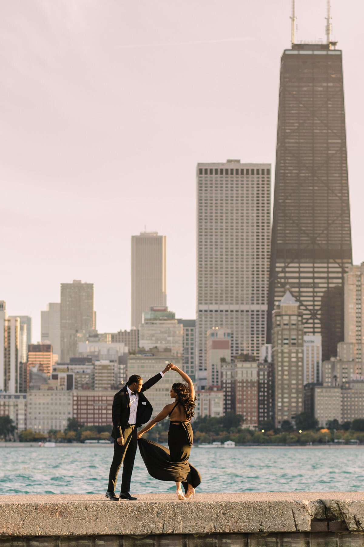 A couple dances in front of the city skyline
