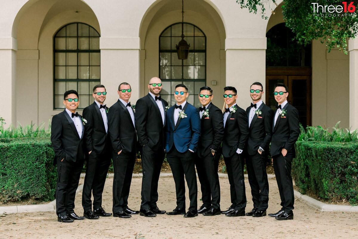 Groom poses with Groomsmen with all wearing sunglasses