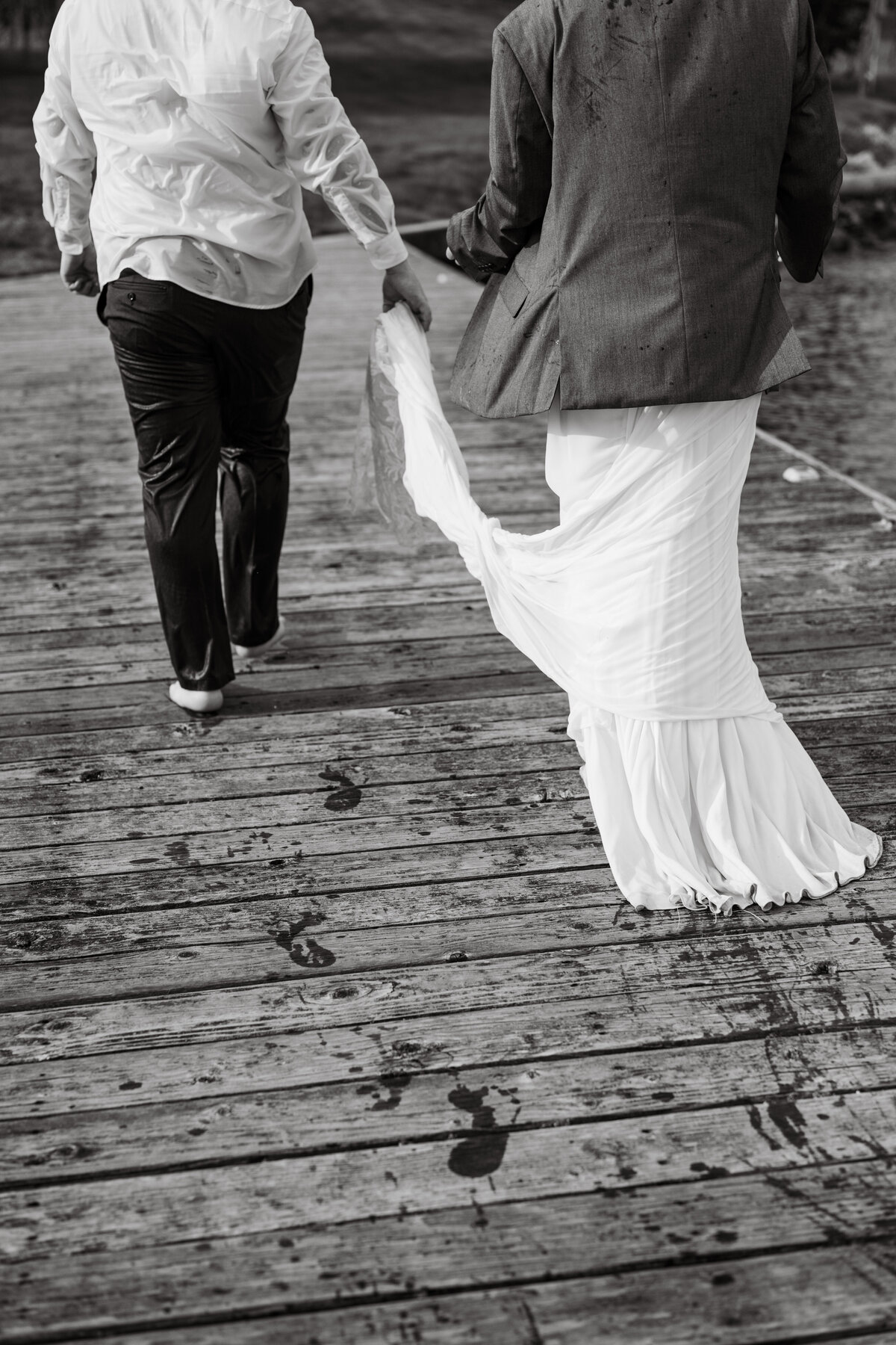 Bride and groom walking on a dock