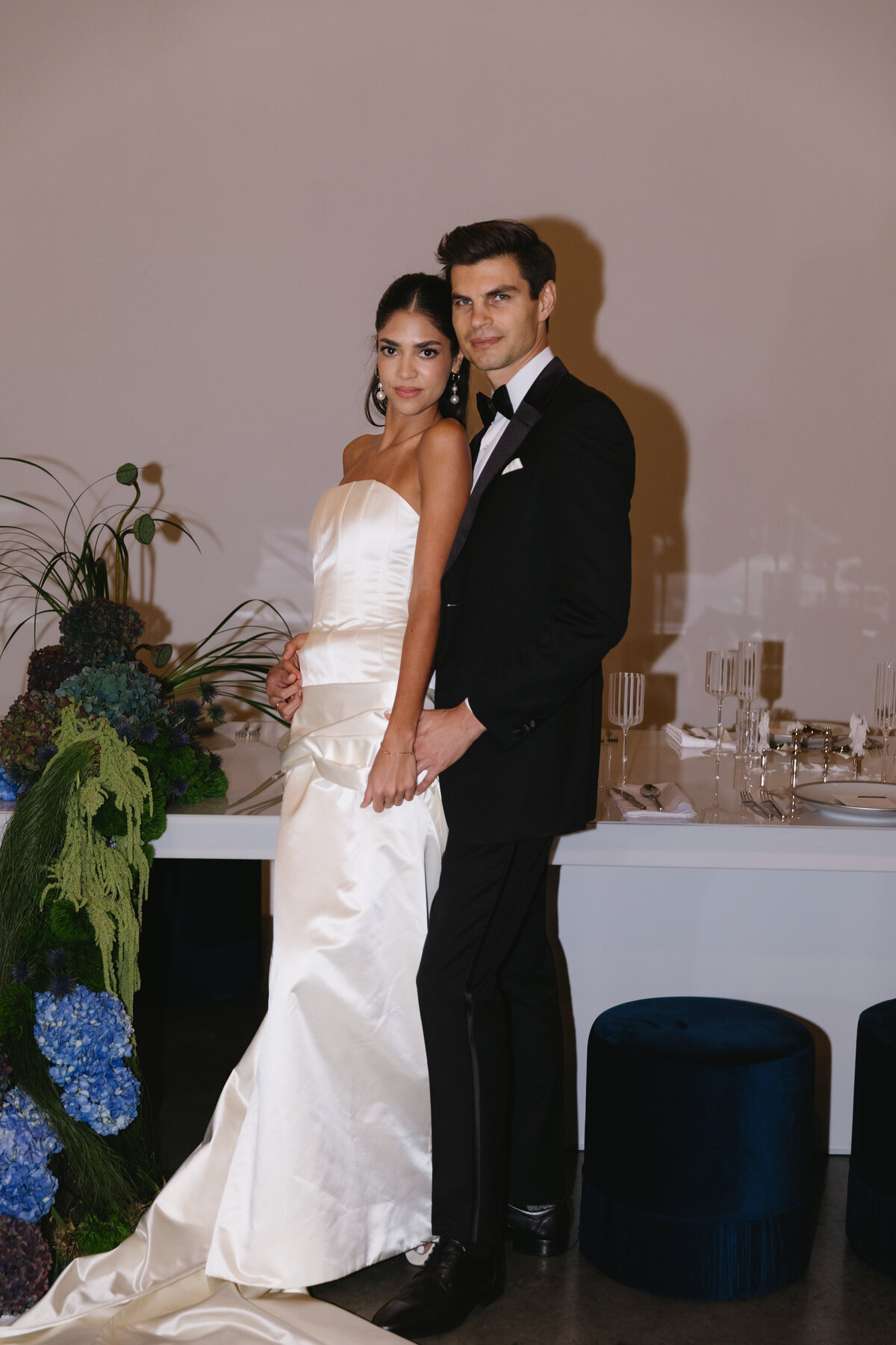 Black-tie wedding couple captured in a refined, editorial-style portrait.
