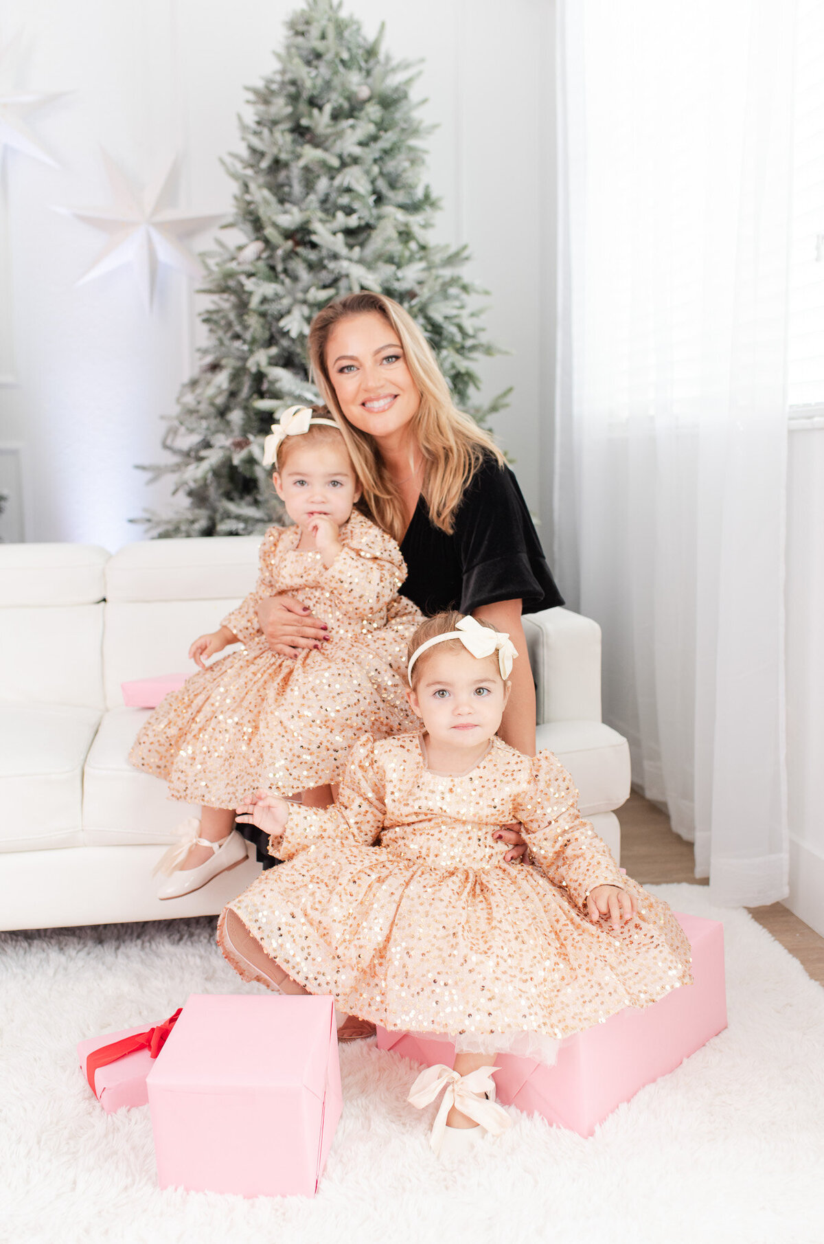 mom with twin girls christmas photoshoot with matchin twin sparkly dresses