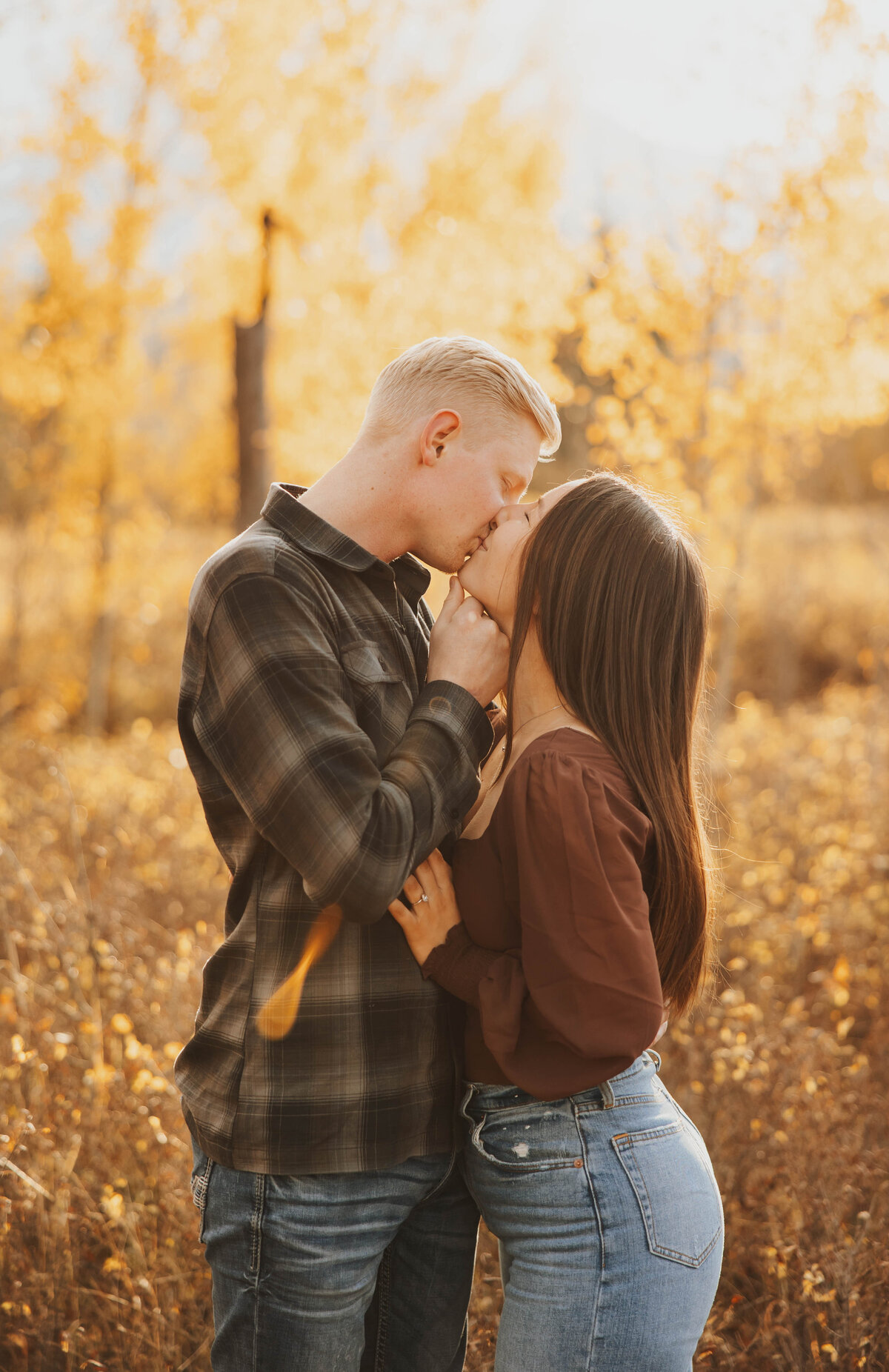 couple kissing in forest