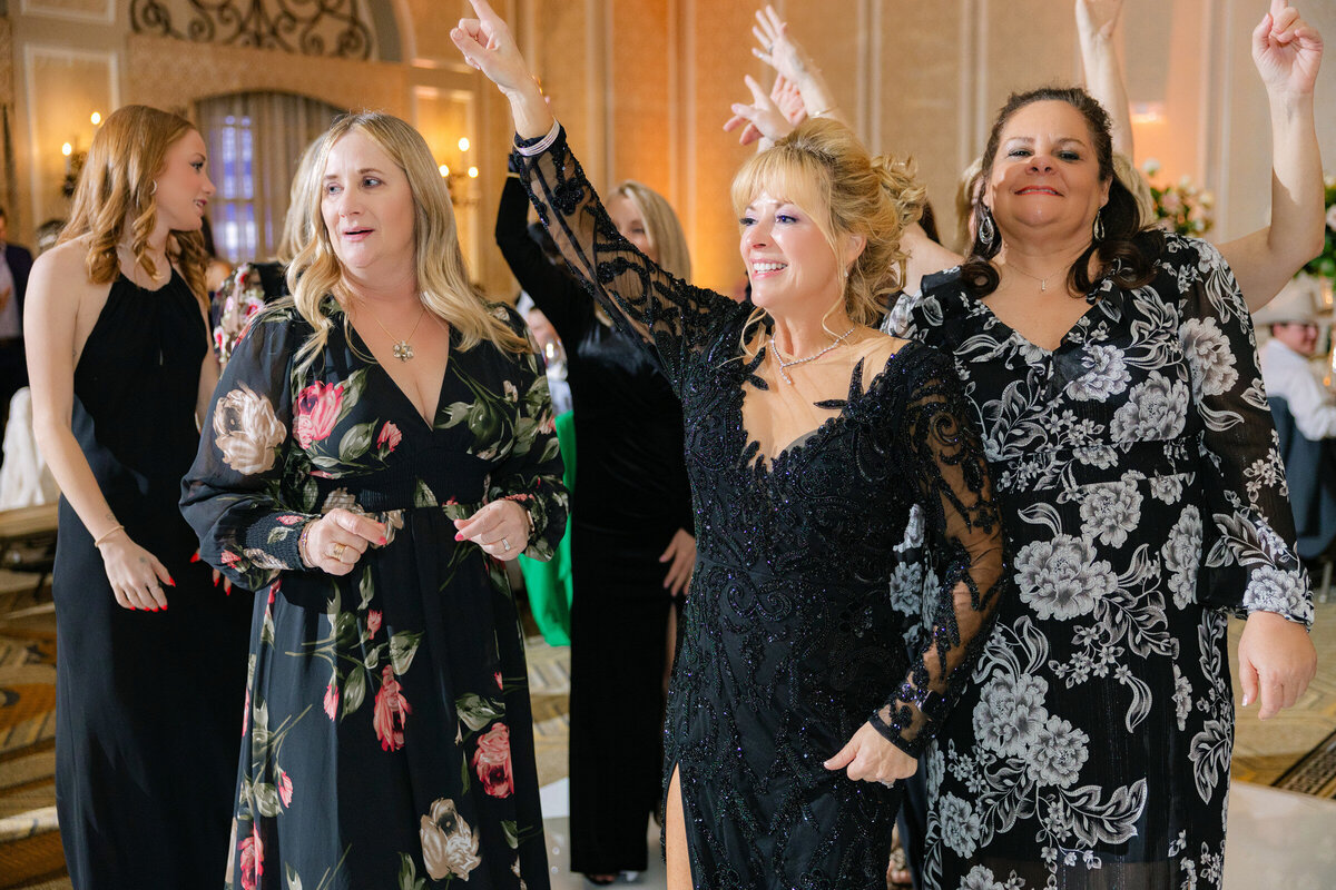 candid moment of the mother of the bride and other guests dancing atThe Adolphus in Dallas