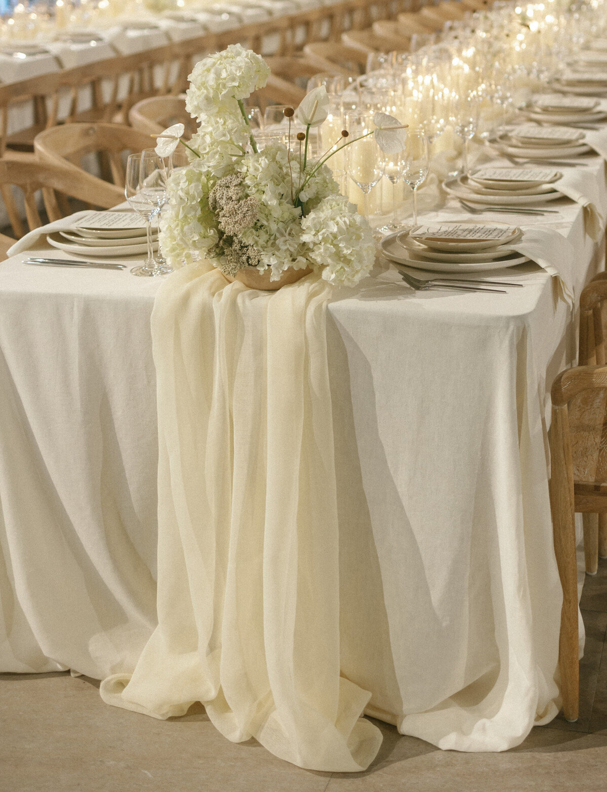 Soft ivory table linens and florals for a unique wedding at State Savings Bank in Detroit