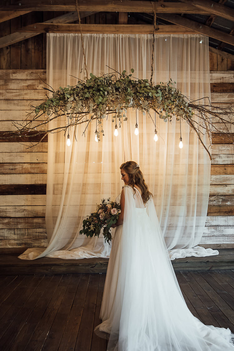 Bride at Meadow Hill Farm holding cascading bridal bouquet with large flowy removable veil