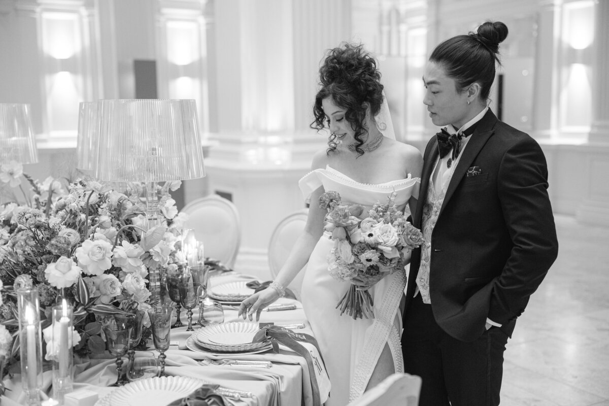 Bride and groom admire their wedding table setup at Andaz Hotel in London, captured by Chi Ramos Photography — multicultural wedding specialist