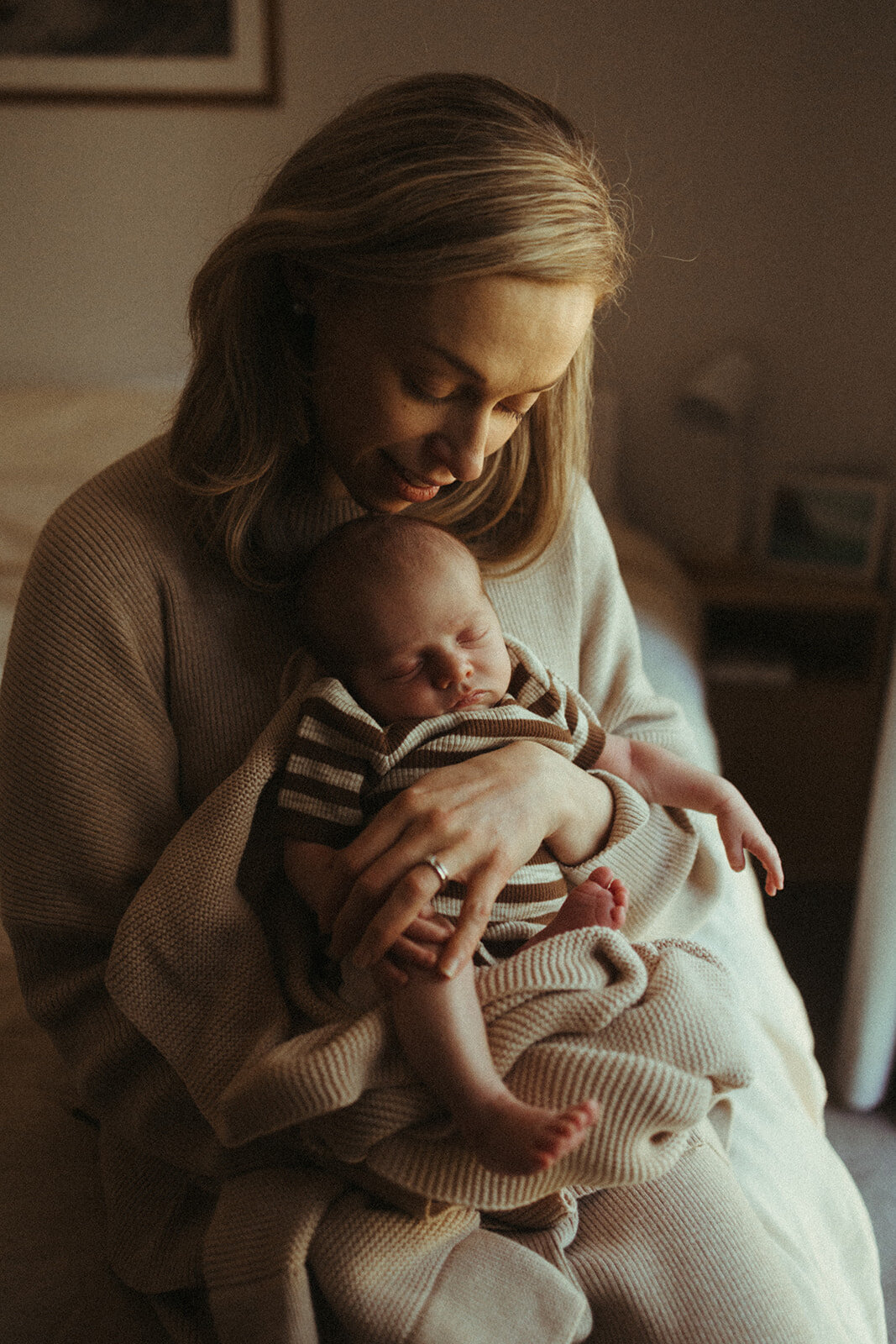 Newborn baby held in mums arms