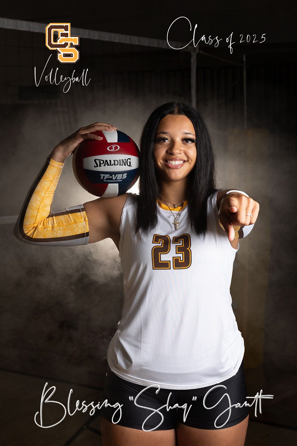 Senior volleyball player poses with ball on her shoulder while pointing at the camera in Murrysville portrait studio.
