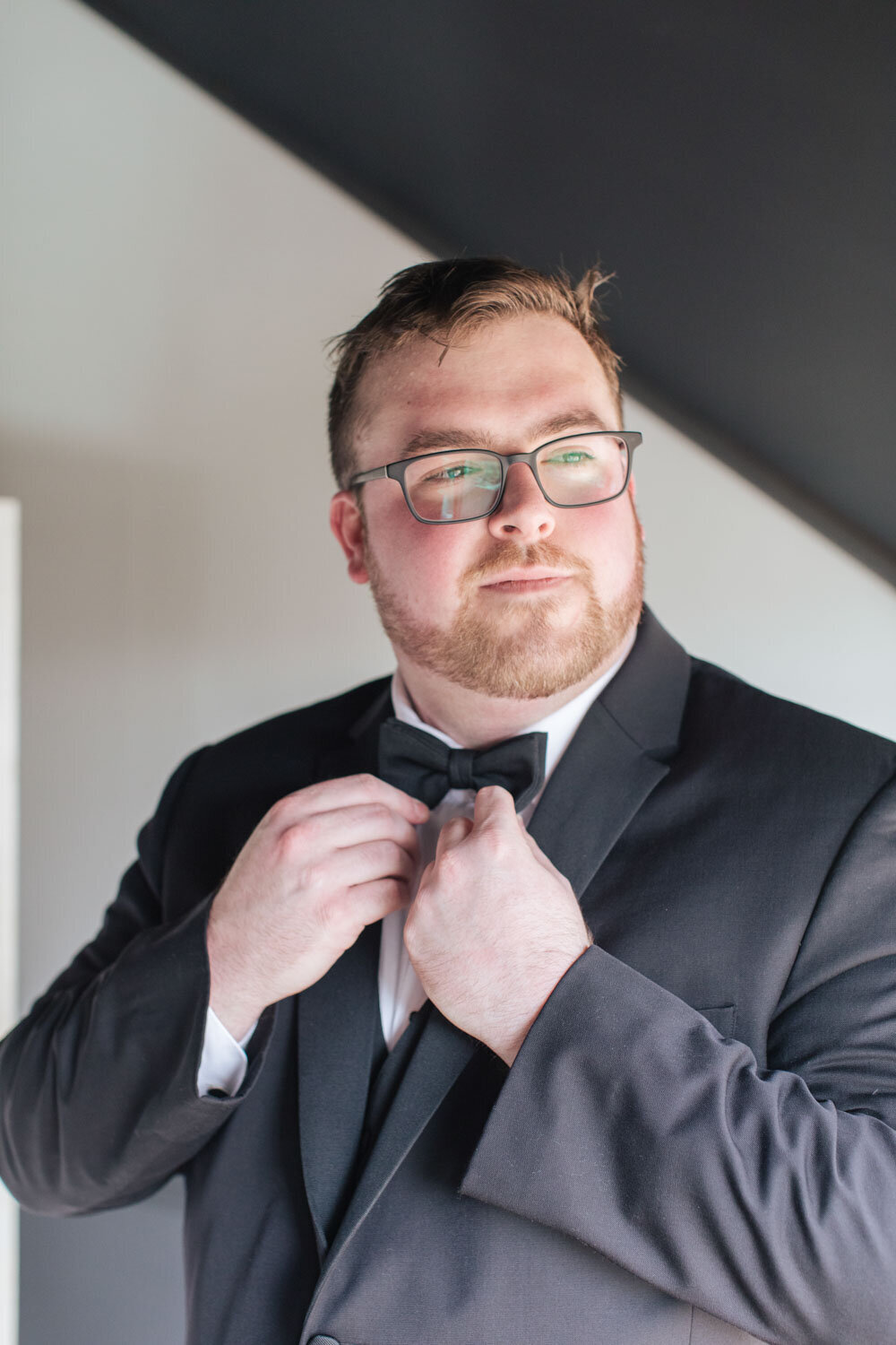 Groom fixing his tie