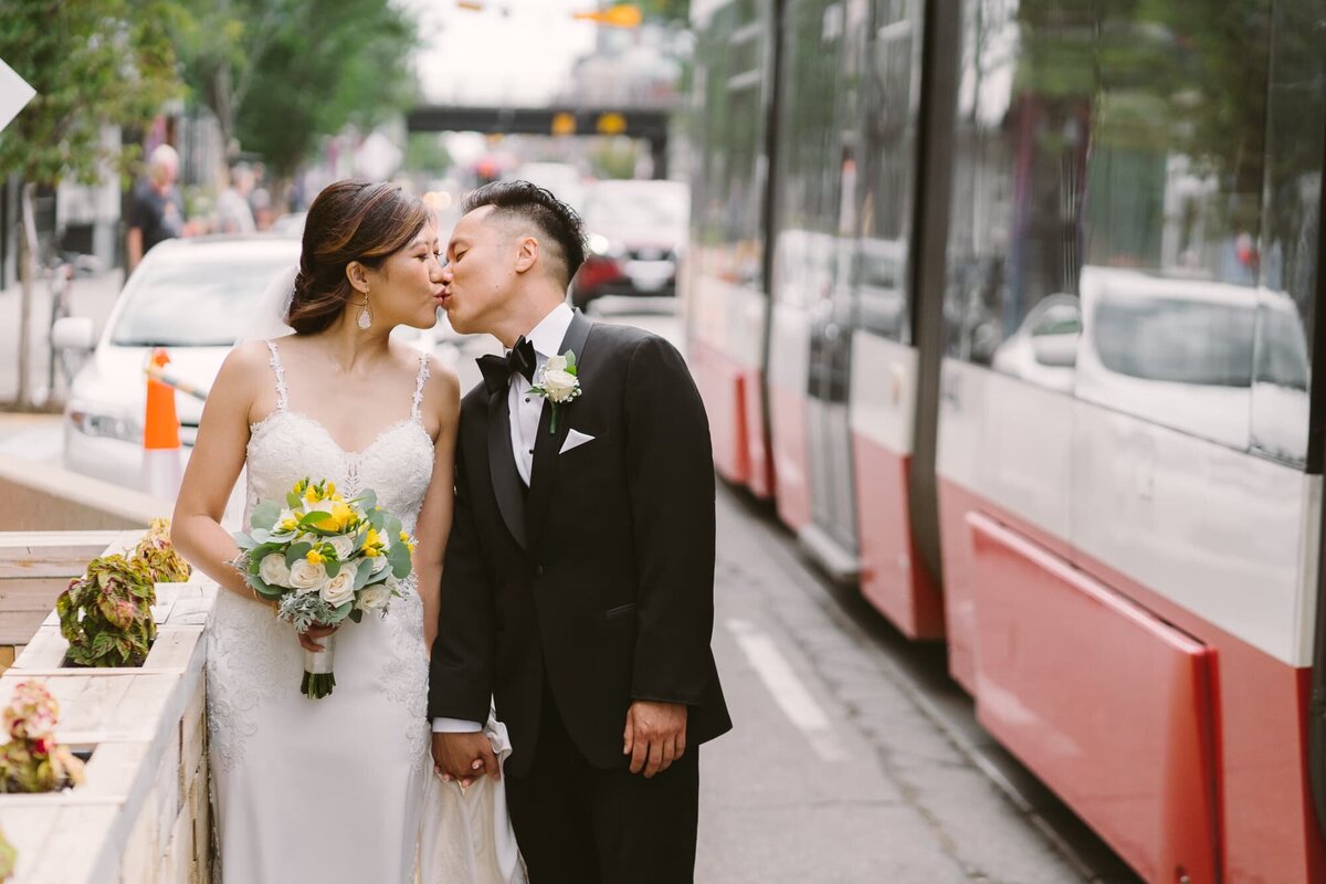 married couple kissing on queen street toronto
