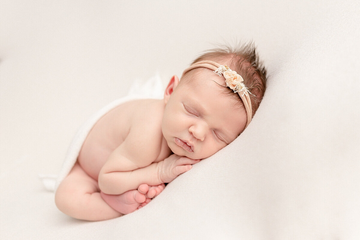 girl sleeping on belly with headband on and mohawk