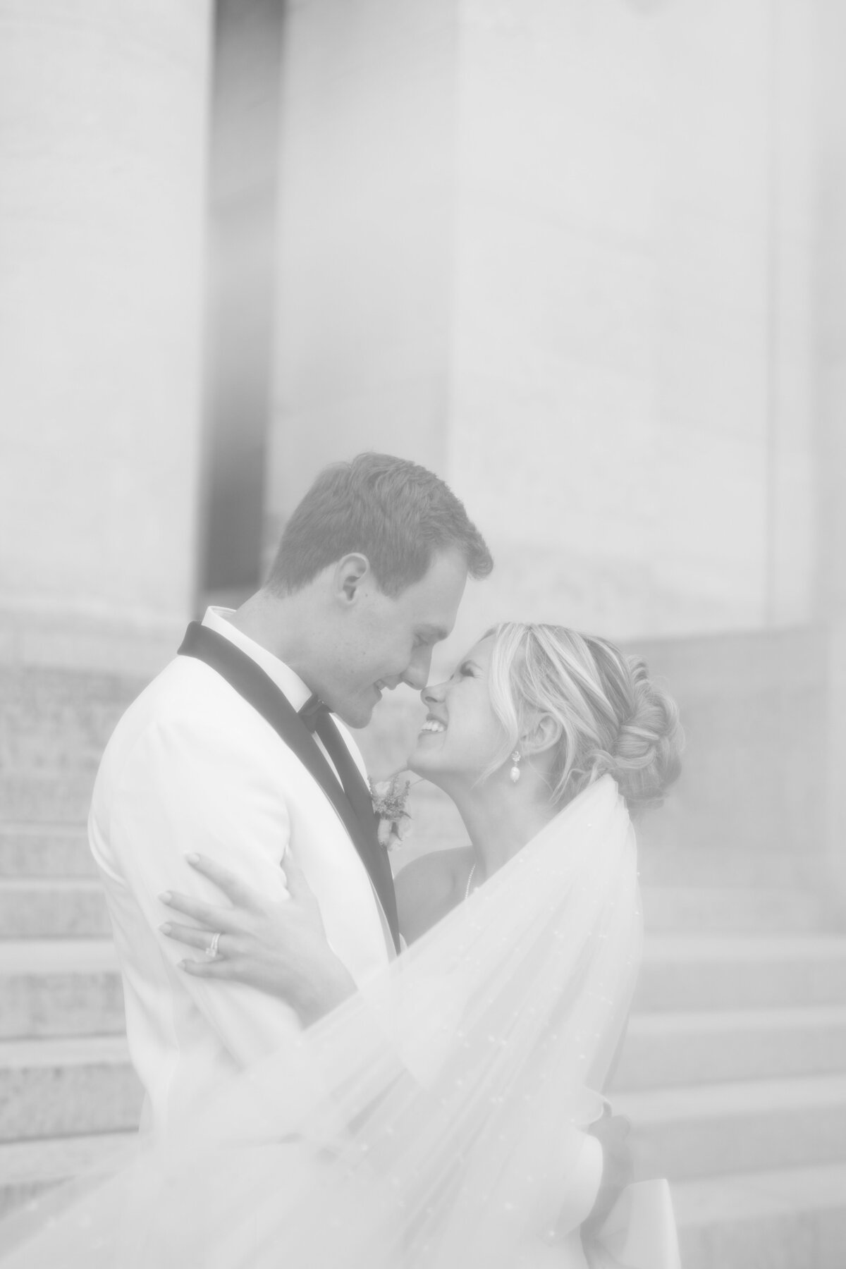 the Westin wedding photos with bride and groom holding each other while touching the tips of their noses together and smiling captured by Columbus wedding  photographer
