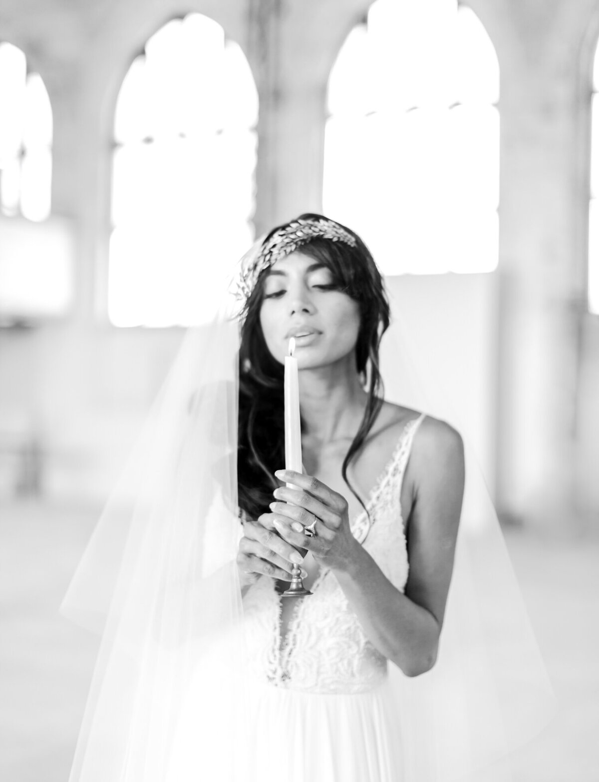 bride with taper candle, leaf headpiece, cathedral ruins wedding in Greece