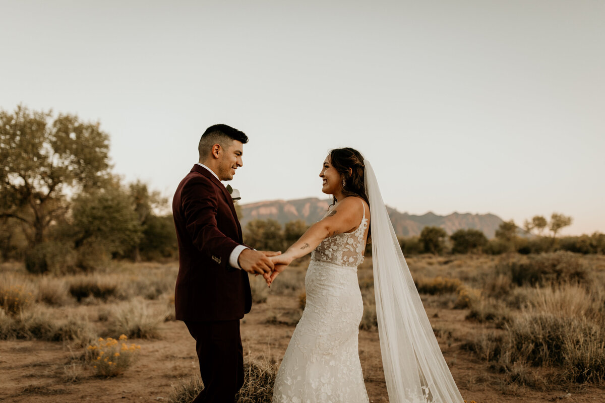 bride and groom dancing together in the desert in Albuquerque