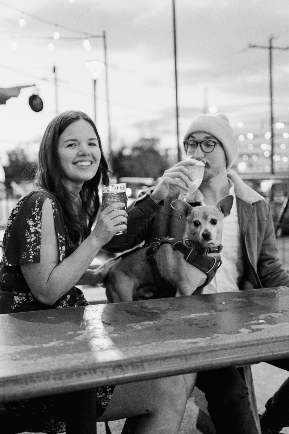Caylin and Will enjoy a candid, in-the-moment engagement session at Wooden Robot Brewery in Charlotte, North Carolina, with their dogs, captured in a documentary style by North Carolina wedding photographer Jessica Leigh Mason.