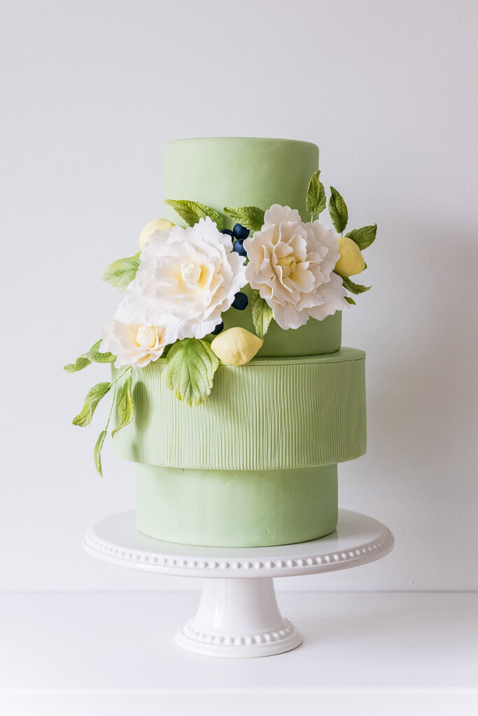 Bold lime coloured four-tiered textured wedding cake, with pink cascading sugar roses, created by Chartier YYC, elegant cakes & desserts in Calgary, AB, featured on the Brontë Bride Vendor Guide.