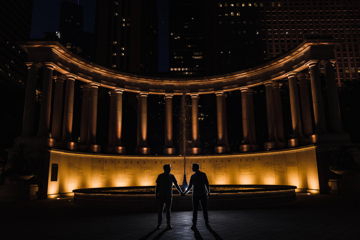 LGBTQ couple is silhouetted  in Chicago Grant Park