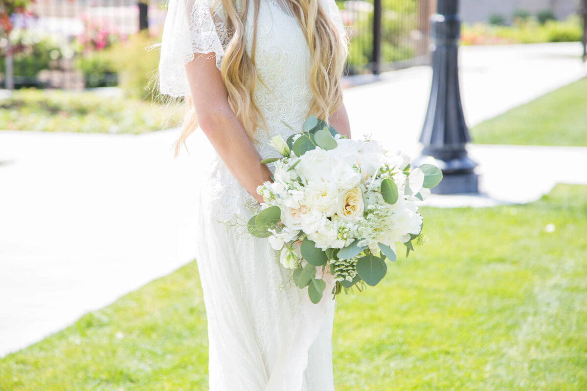 bride holding a bouquet on a sunny day