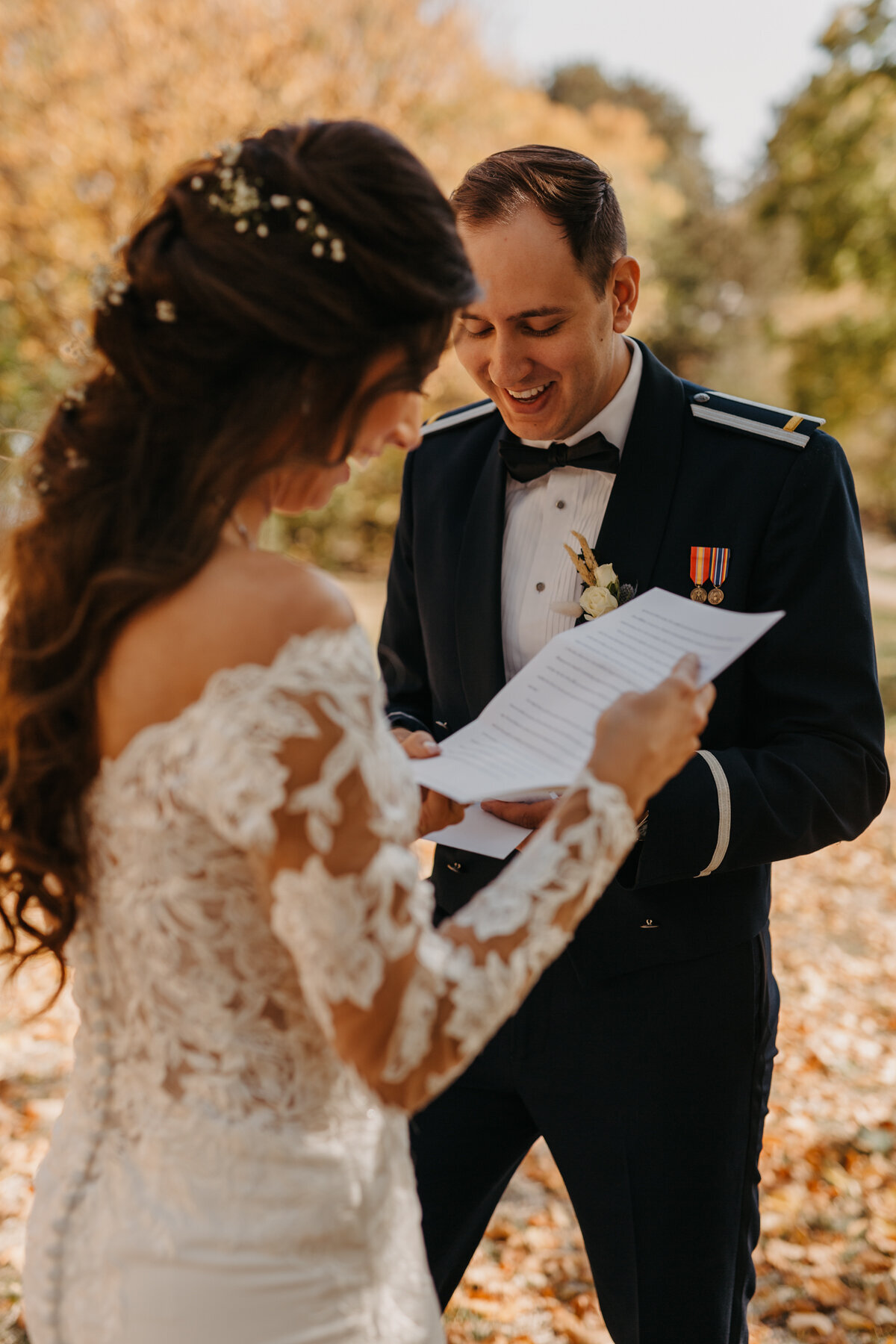 bride and groom reading letters they gifted each other and both people are smiling