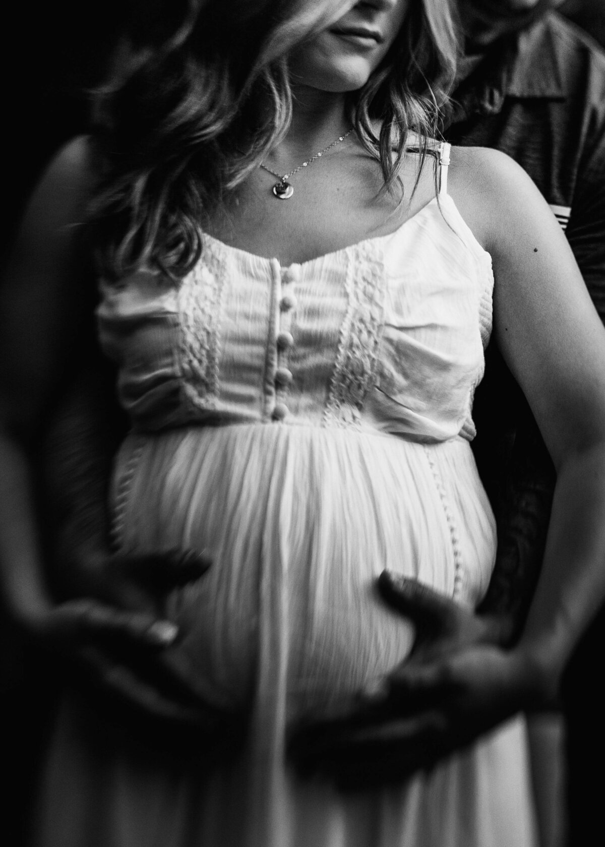 A black and white photo of a pregnant woman captured by a Pittsburgh maternity photographer.