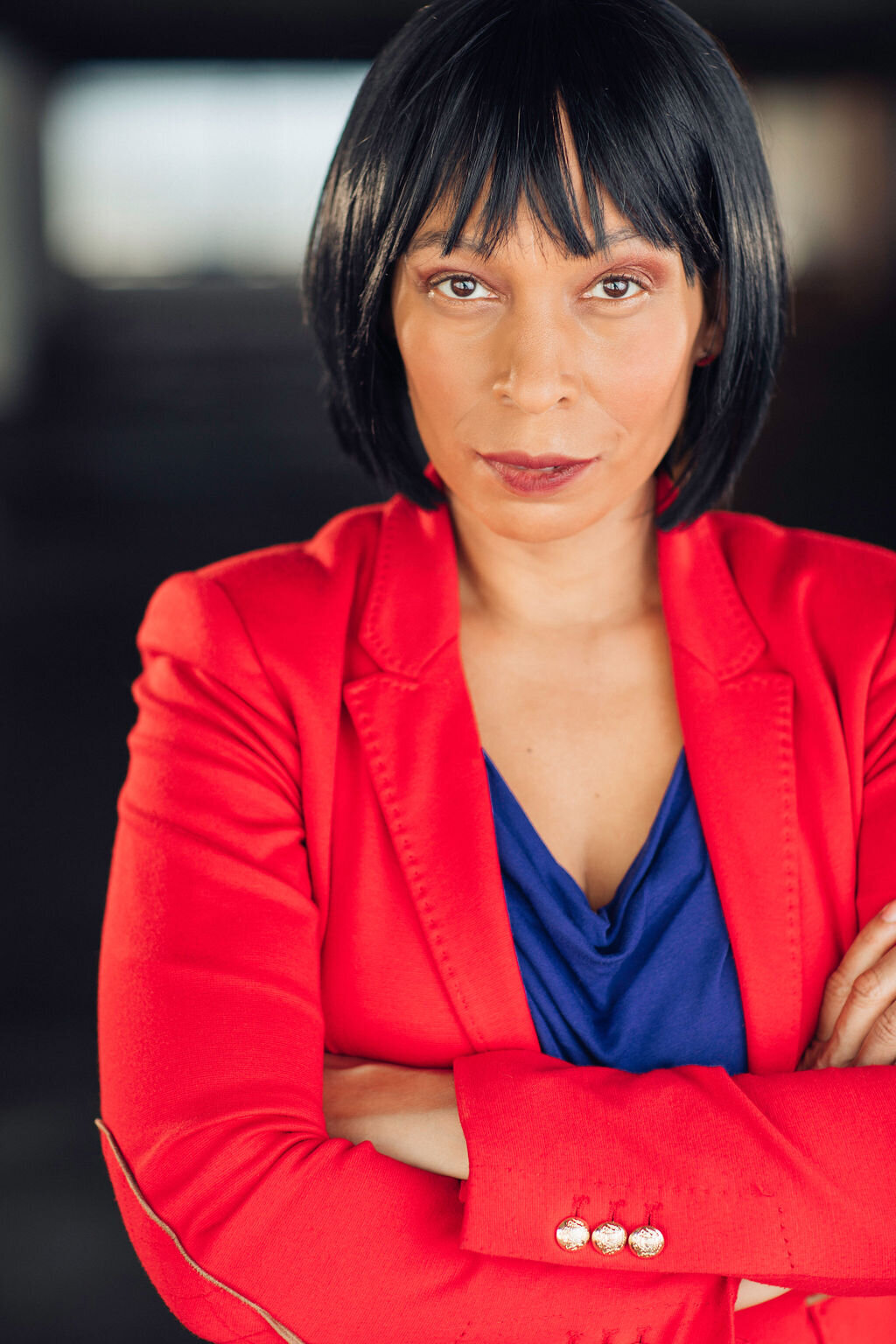 Headshot Photograph Of Woman In Outer Red Blazer And Inner Blue Violet Blouse Los Angeles
