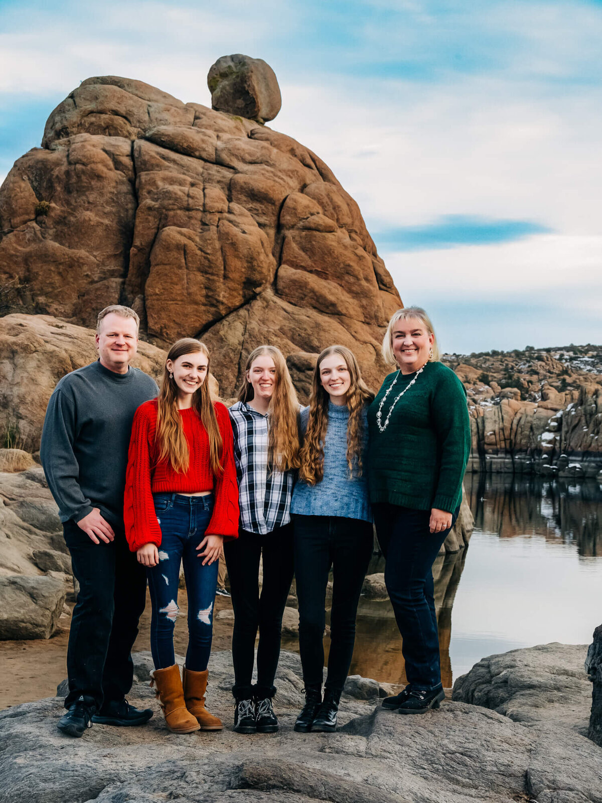 Family poses in front of giant boulder at Watson Lake for Prescott family photos with Melissa Byrne
